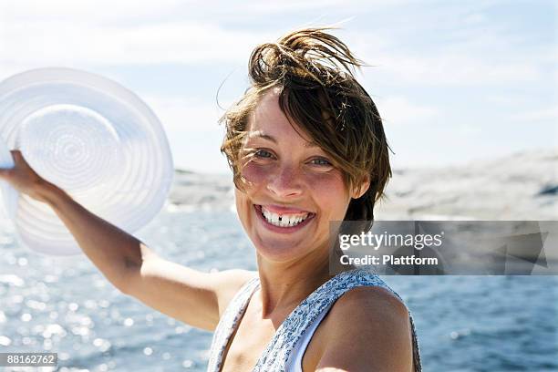 a smiling scandinavian woman in the archipelago sweden. - vrouw spleetje tanden stockfoto's en -beelden