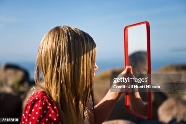 a girl looking in a mirror oland sweden. - vanity stock pictures, royalty-free photos & images
