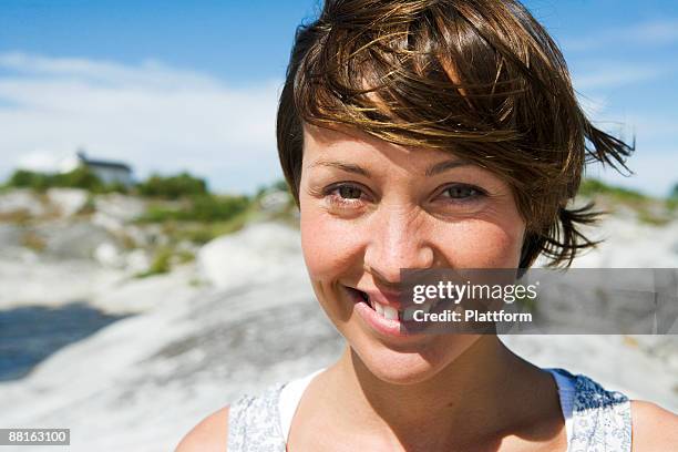 a smiling scandinavian woman in the archipelago sweden. - vrouw spleetje tanden stockfoto's en -beelden