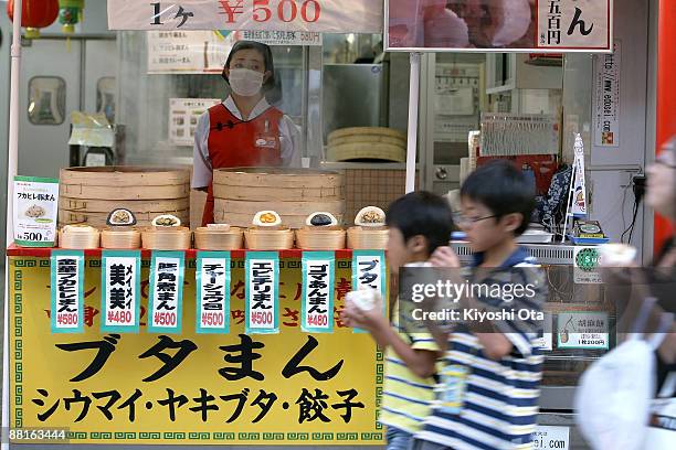 Visitors walk past a steamed bun shop in Yokohama Chinatown, which is the largest Chinatown in Asia, on June 2, 2009 in Yokohama, Japan. Yokohama,...