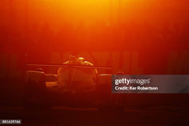 The Toyota Gazoo Racing TS050 of Mike Conway, Kamui Kobayashi and Stephane Sarrazin drives at sunset during the Le Mans 24 Hours race at the Circuit...