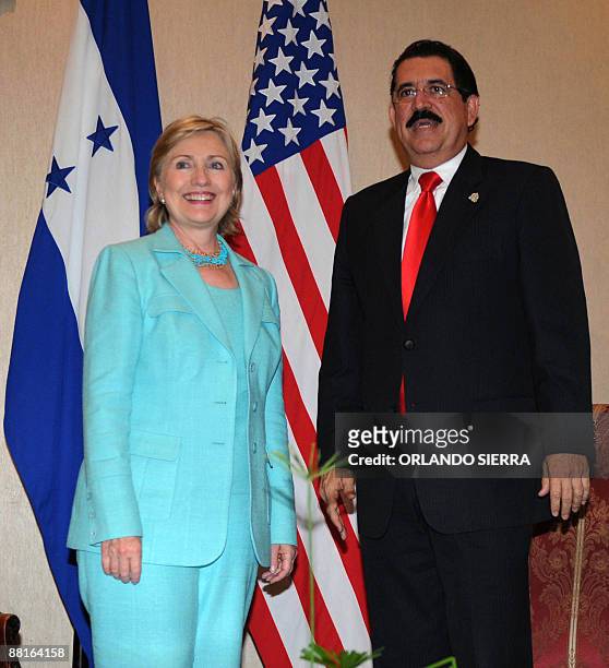 Honduras' President Manuel Zelaya says farewell to US Secretary of State Hillary Clinton before she leaves after attending the 39th General Assembly...