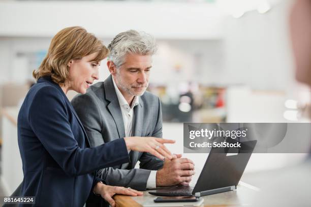 meeting with the manager - serious business talk stock pictures, royalty-free photos & images