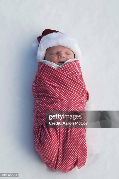 wrapped baby in snow - bundle stock pictures, royalty-free photos & images