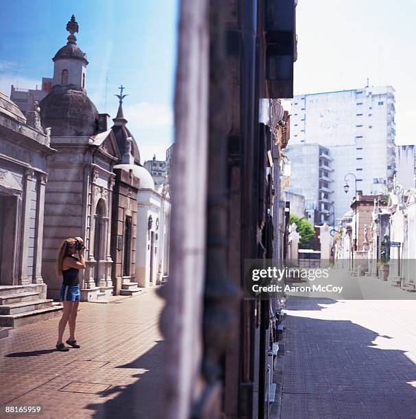 woman taking picture of mausoleums, buenos aires, argentina - la recoleta cemetery stock pictures, royalty-free photos & images