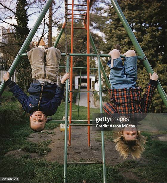 children hanging upside down - family garden play area stock pictures, royalty-free photos & images