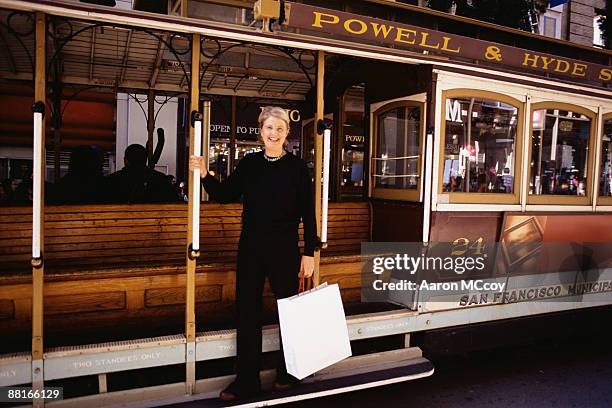 woman on trolley with shopping bag - san francisco tram stock pictures, royalty-free photos & images