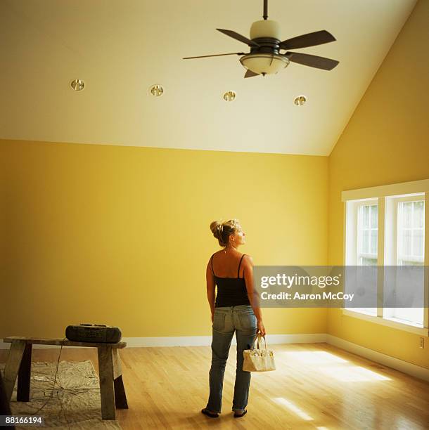 woman standing in empty room - recessed lighting ceiling stock pictures, royalty-free photos & images