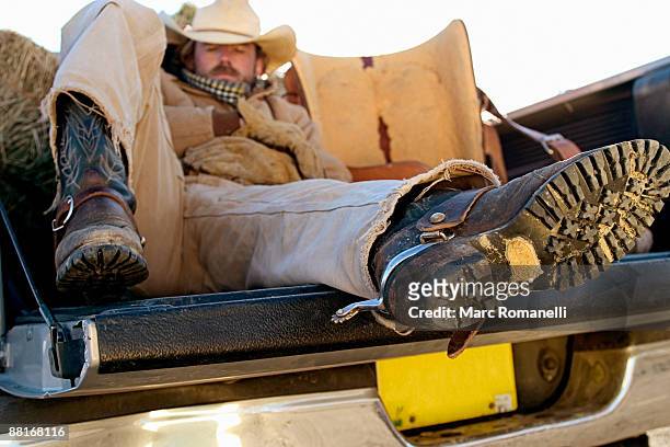 cowboy lying in pickup truck - cowboy sleeping stock pictures, royalty-free photos & images