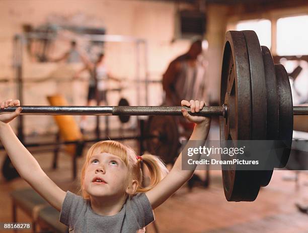 girl lifting weights - young kid and barbell stock-fotos und bilder