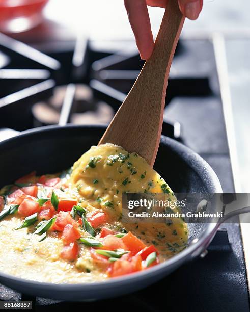 person cooking omelette - omelette stock pictures, royalty-free photos & images