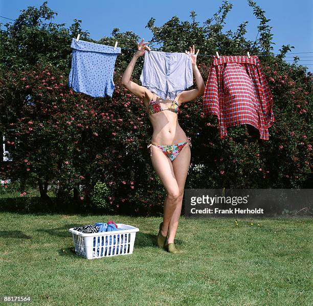 woman hanging up laundry - drying stock pictures, royalty-free photos & images