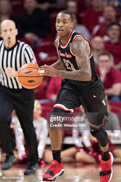 Deshon Taylor of the Fresno State Bulldogs dribbles down the court during a game against the Arkansas Razorbacks at Bud Walton Arena on November 17,...