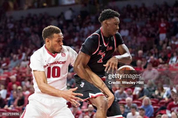 Daniel Gafford of the Arkansas Razorbacks knocks the ball away from Jaron Hopkins of the Fresno State Bulldogs at Bud Walton Arena on November 17,...