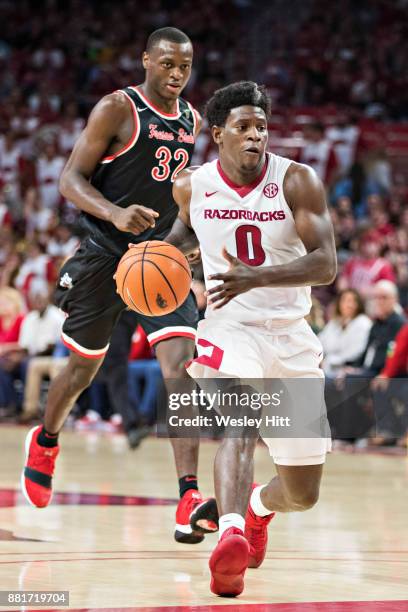 Jaylen Barford of the Arkansas Razorbacks drives around Nate Grimes of the Fresno State Bulldogs at Bud Walton Arena on November 17, 2017 in...