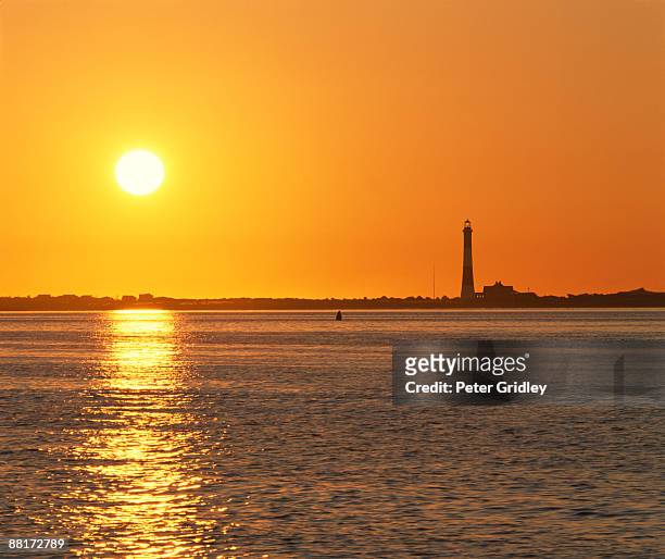 lighthouse at sunset - leuchtturm fire island stock-fotos und bilder
