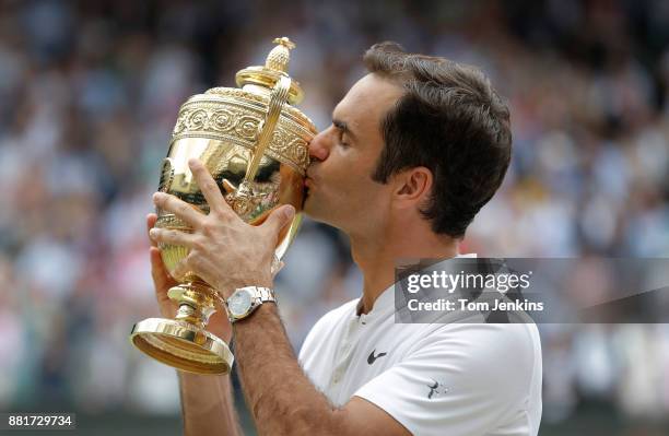 Roger Federer kisses the trophy after winning the men's singles final against Marin Cilic on Centre Court on day thirteen of the 2017 Wimbledon...