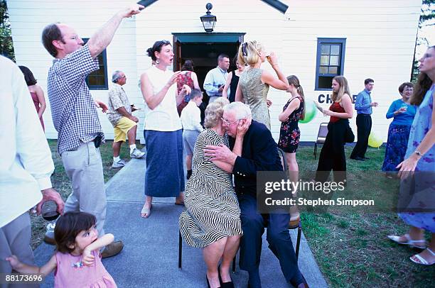 couple embracing at wedding anniversary celebration - wedding anniversary stockfoto's en -beelden