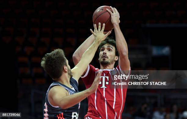 Bayern Munich's football defender Mats Hummels shoots the ball during a basketball match at a sponsor fan event in Munich, southern Germany, on...