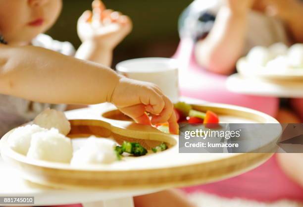 little child eating meal with bare hands,close up - baby eating food imagens e fotografias de stock