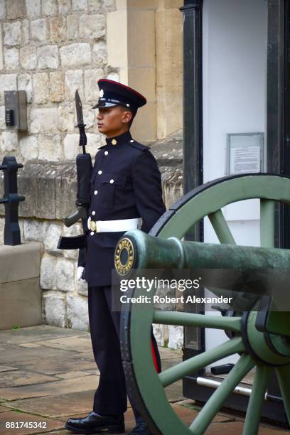 An armed sentry stands at his post in the Tower of London complex in London, England. The sentry is a part of a military guard stationed at the Tower...