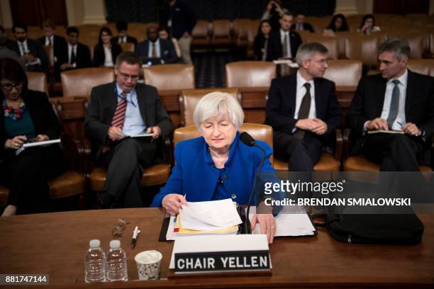 Federal Reserve Chairman Janet Yellen looks at her papers before a hearing of the Joint Economic Committee on Capitol Hill, November 29 in...