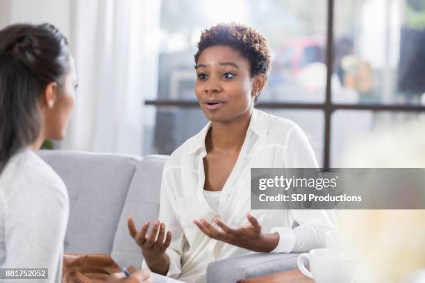 concerned woman talks with therapist - mental alertness stock pictures, royalty-free photos & images