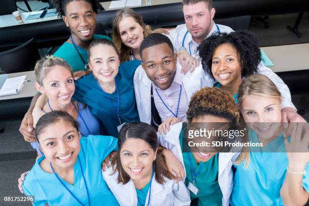 view from above of medical students in lecture hall - american college of physicians stock pictures, royalty-free photos & images