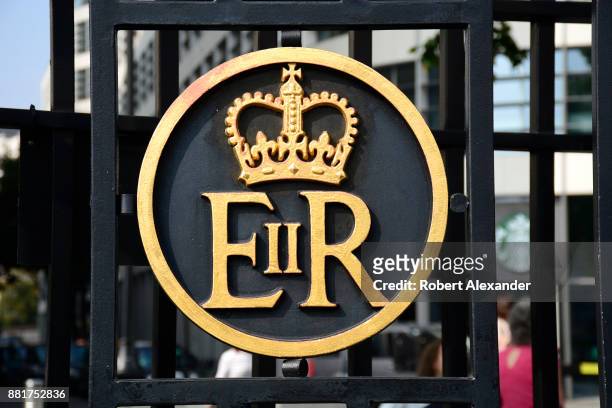 Metal gate near the Tower of London in London, England, includes a royal crown and 'ER II' which stands for Elizabeth Regina the Second, or Queen...