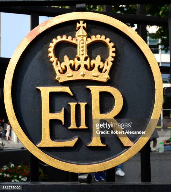 Metal gate near the Tower of London in London, England, includes a royal crown and 'ER II' which stands for Elizabeth Regina the Second, or Queen...