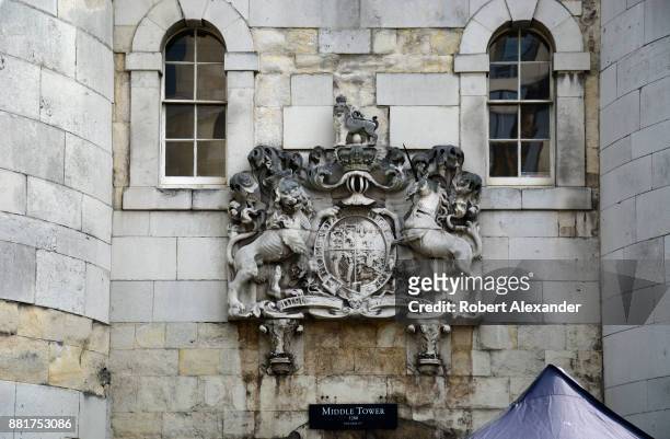 Stone carving of the royal coat of arms of the United Kingdom, or the Royal Arms for short, is embedded in the wall above the Middle Tower entrance...