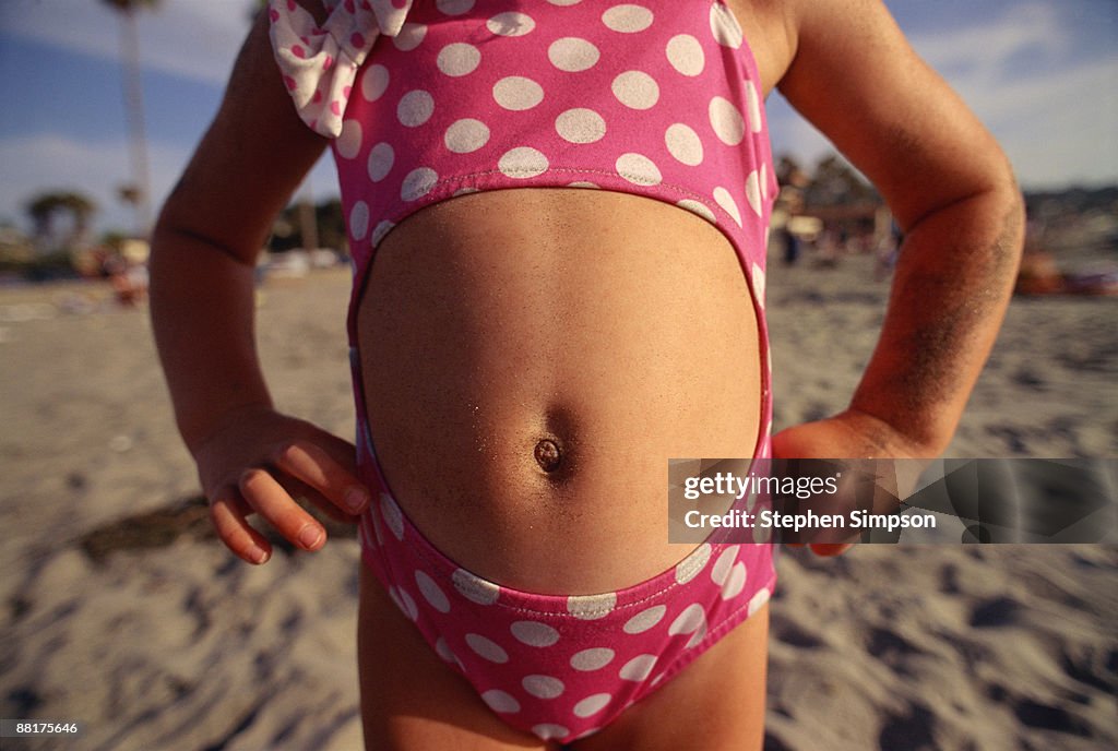 Close-up of girl's belly button in swimsuit