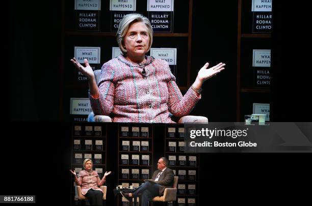 Former U.S. Presidential candidate Hillary Clinton, left, and on video board above, speaks during an event held at the Boston Opera House to discuss...