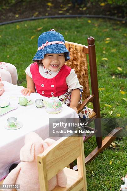 toddler girl having tea party - tea party hats for kids stock pictures, royalty-free photos & images