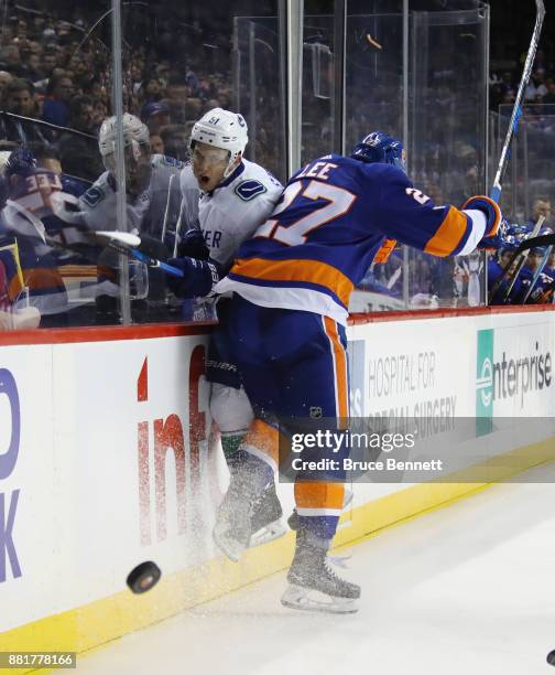 Anders Lee of the New York Islanders steps into Troy Stecher of the Vancouver Canucks at the Barclays Center on November 28, 2017 in the Brooklyn...