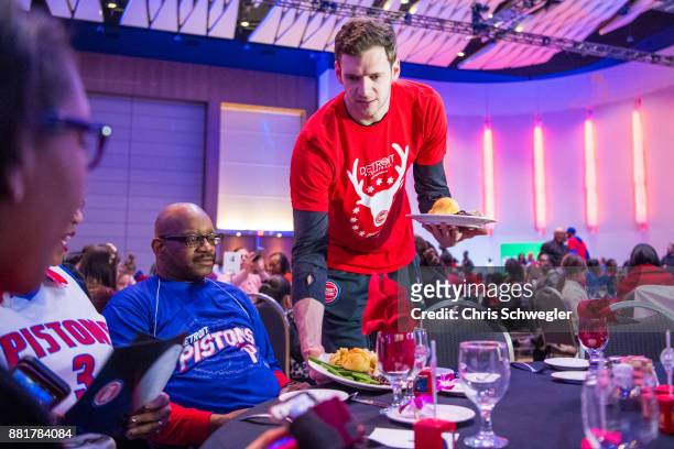 Jon Leuer of the Detroit Pistons helps serve food during the seventh annual Thanksgiving Holiday Meal at Cobo Center in Detroit on Nov 22, 2017. The...