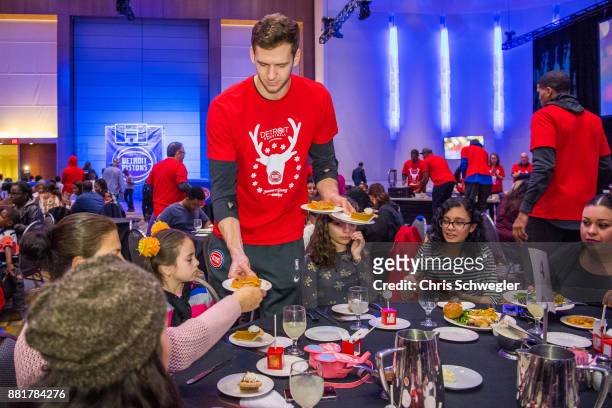 Jon Leuer of the Detroit Pistons helps serve food during the seventh annual Thanksgiving Holiday Meal at Cobo Center in Detroit on Nov 22, 2017. The...