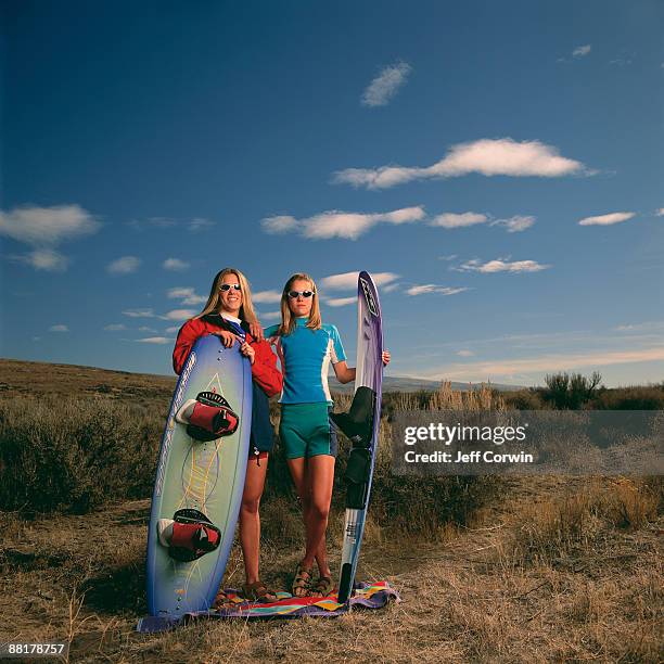 women with wakeboards - wasserski stock-fotos und bilder