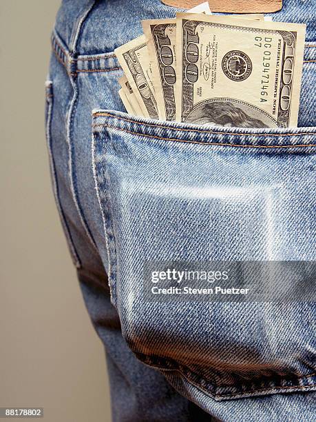 back pocket bulging with money - bolso traseiro imagens e fotografias de stock