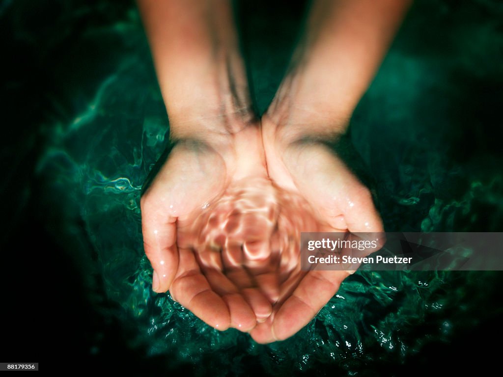 Pair of hands cupping water
