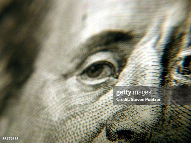 close up of benjamin franklin's eyes and nose on currency - money politics stock pictures, royalty-free photos & images