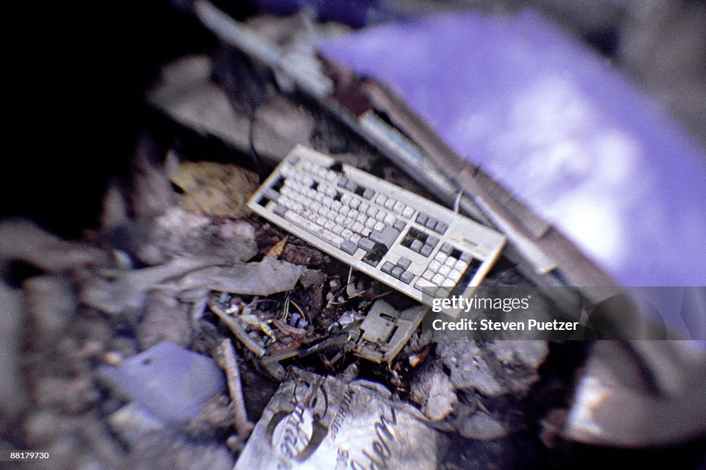 Computer keyboard in a junk pile