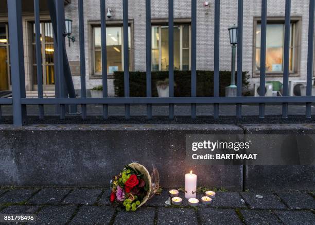 Flowers and candles stand outside The International Criminal Tribunal for the former Yugoslavia at The Hague, The Netherlands on November 29 after...