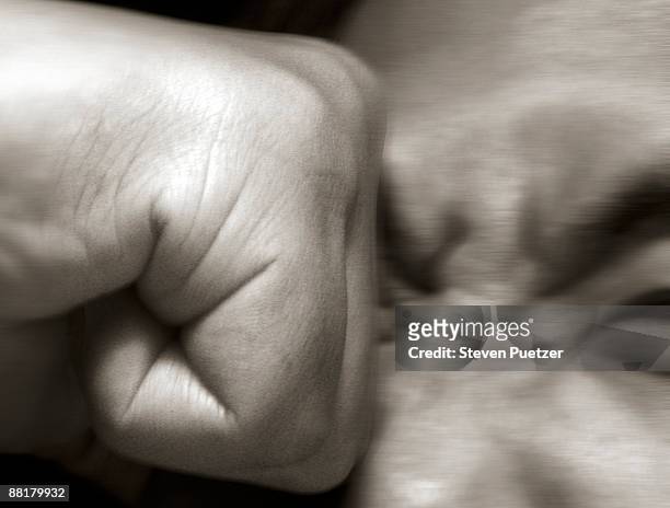 fist punching a man in the eye - punching stock pictures, royalty-free photos & images