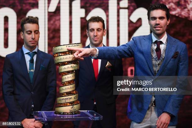 Title holder Tom Dumoulin of Netherlands poses next to Italian riders Fabio Aru and Vincenzo Nibali with the trophy of the Giro d'Italia during the...