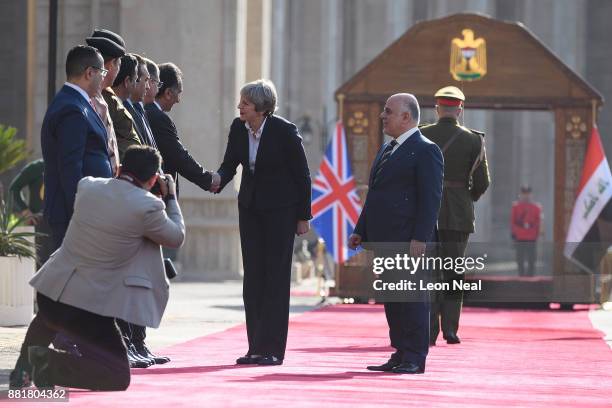 British Prime Minister Theresa May is introduced to members of the Iraq delegation by Iraqi Prime Minister Haider Al-Abadi , ahead of a bi-lateral...