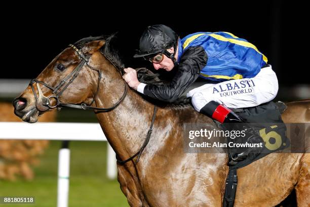 Adam Kirby riding Higher Court win The 32Red On The App Store Handicap Stakes at Kempton racecourse on November 29, 2017 in Sunbury, United Kingdom.