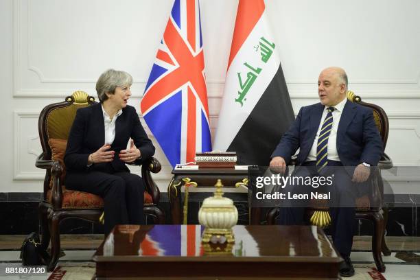 British Prime Minister Theresa May and Iraqi Prime Minister Haider Al-Abadi pose for photographs ahead of a bi-lateral meeting in the Government...