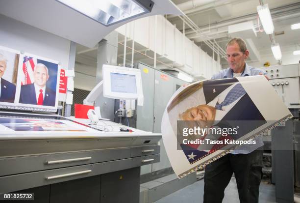 Pressman Mike Stone takes samples from the printing press to check the color on the official photograph of President Donald J. Trump at the...