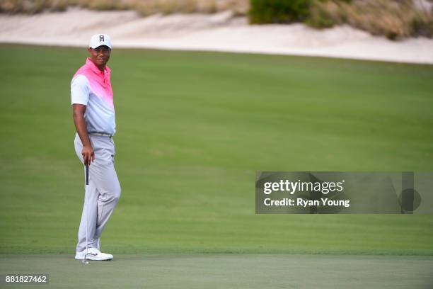 Tiger Woods watches his playing partners during practice for the Hero World Challenge at Albany course on November 29, 2017 in Nassau, Bahamas.